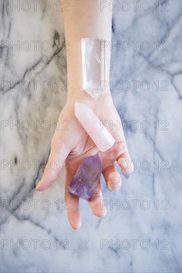 Hand of Caucasian woman holding crystals