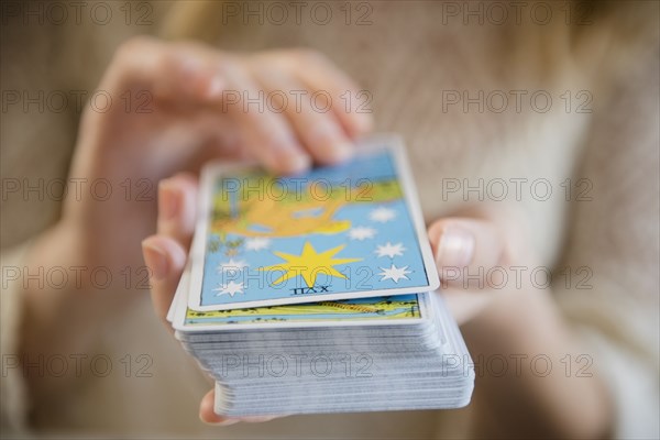 Caucasian woman holding a deck of tarot cards