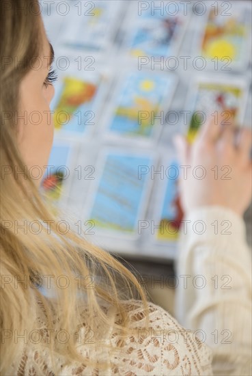 Caucasian woman using tarot cards