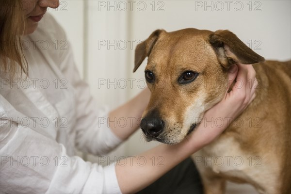 Caucasian woman hugging dog