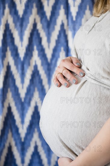 Caucasian expectant mother holding Valley near pattern