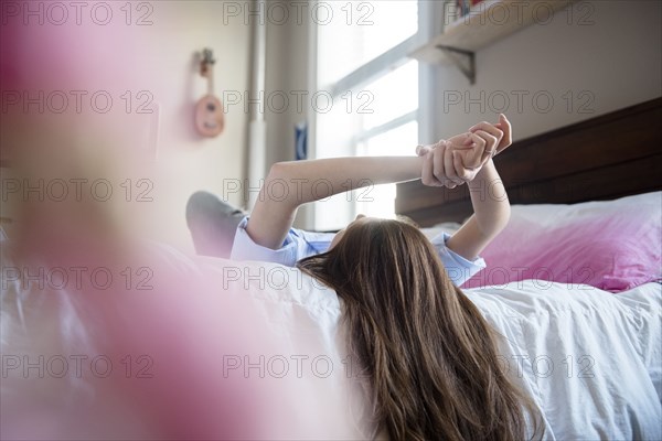 Caucasian woman relaxing on bed