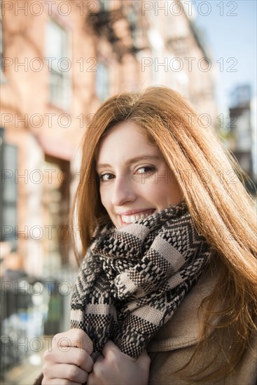 Portrait of smiling Caucasian woman wearing scarf