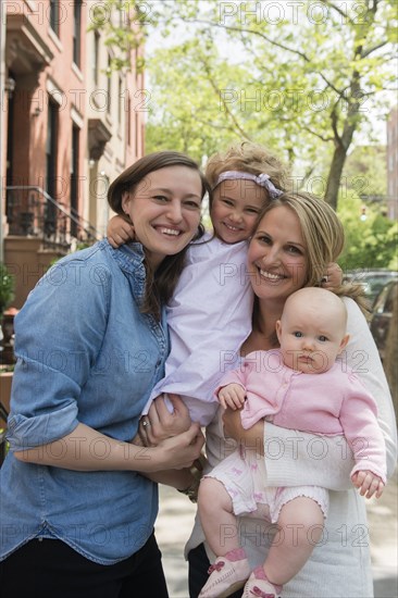 Portrait of Caucasian mothers and daughters in city