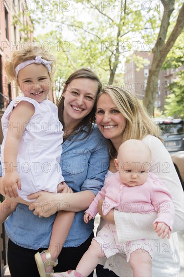 Portrait of Caucasian mothers and daughters in city