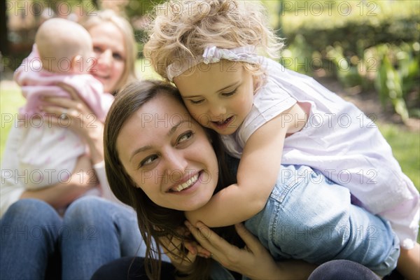 Caucasian girl hugging mother