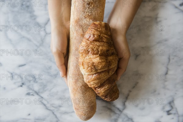 Hands of African American woman holding bread