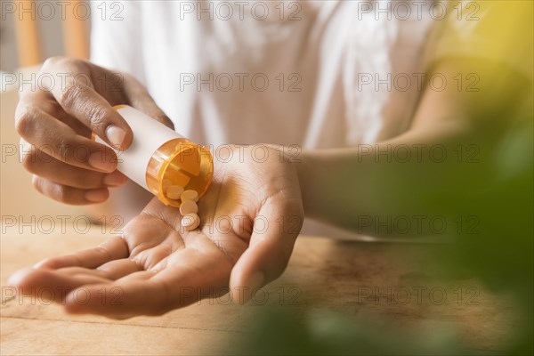 Hands of African American woman holding prescription medicine