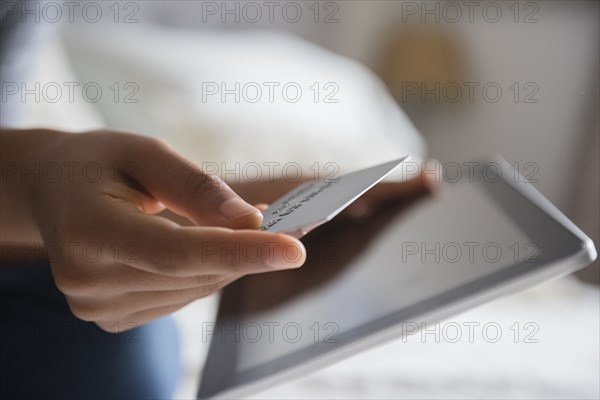 Hands of African American woman online shopping with digital tablet