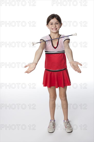 Caucasian girl twirling a baton