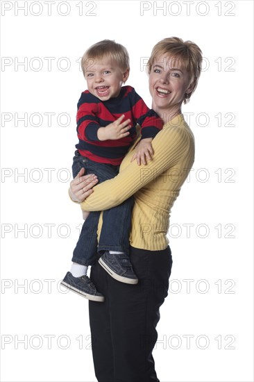 Caucasian mother holding son