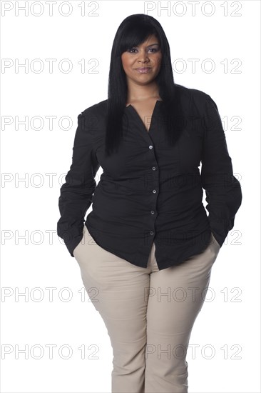 Hispanic woman with hands in pockets