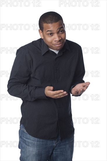 Smiling man making questioning gesture