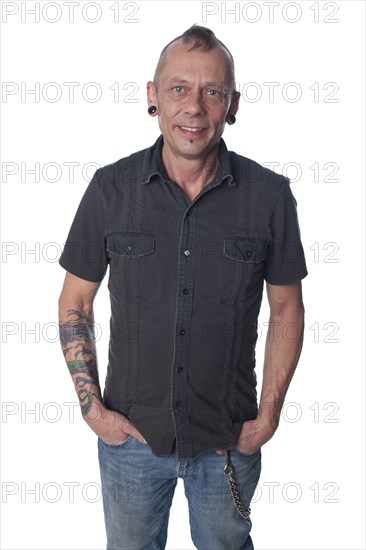 Tattooed Caucasian man with hands in pockets