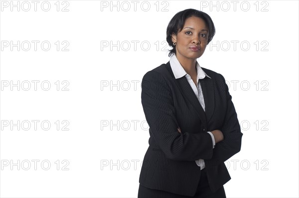 Serious mixed race businesswoman with arms crossed