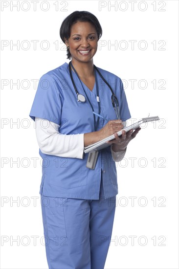 Mixed race doctor writing in medical chart