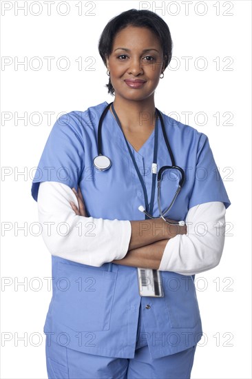 Smiling mixed race doctor with arms crossed