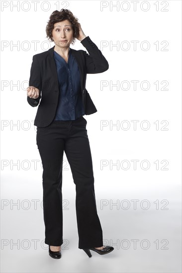 Smiling businesswoman scratching her head