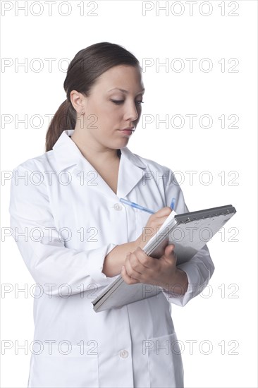 Caucasian doctor writing on medical record