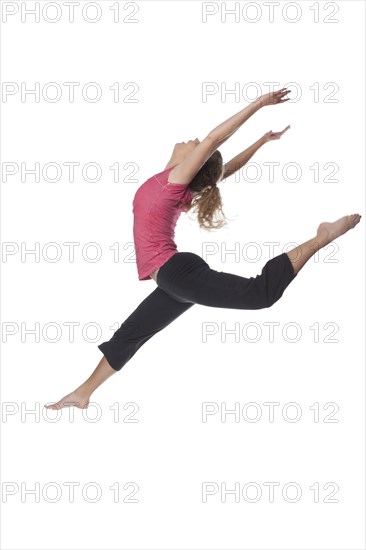 Caucasian woman jumping in mid-air