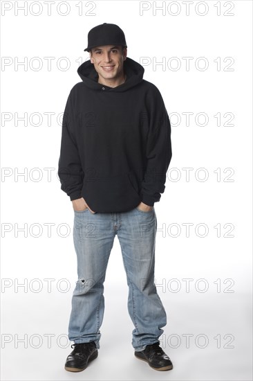 Mixed race man in sweatshirt and baseball cap