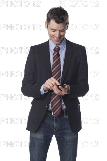 Caucasian businessman text messaging on cell phone