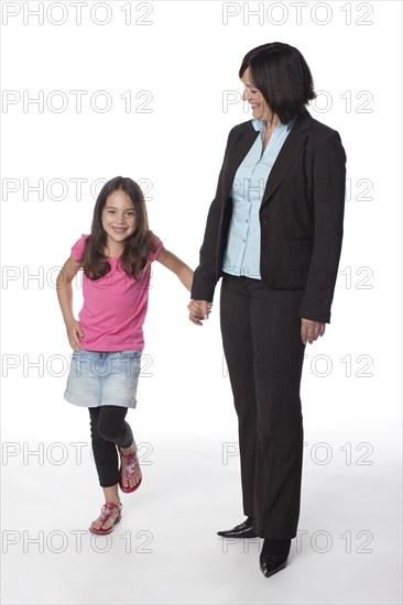 Caucasian mother and daughter holding hands