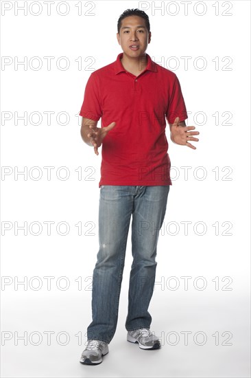 Smiling Hispanic man with arms outstretched