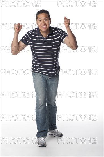 Smiling Hispanic man cheering