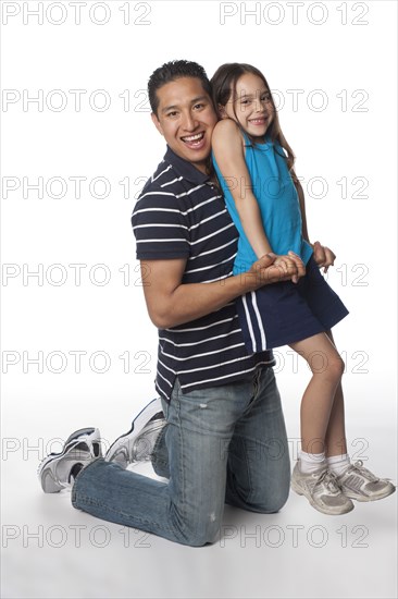 Hispanic father and daughter playing
