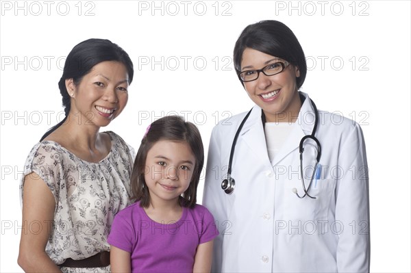 Smiling doctor standing with mother and daughter