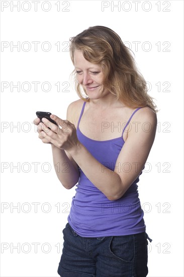 Caucasian woman text messaging on cell phone