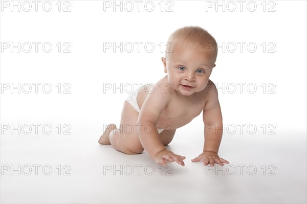 Caucasian baby boy crawling