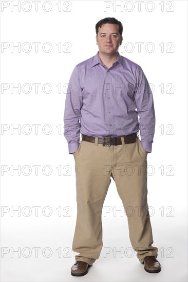 Serious Caucasian man with hands in pockets