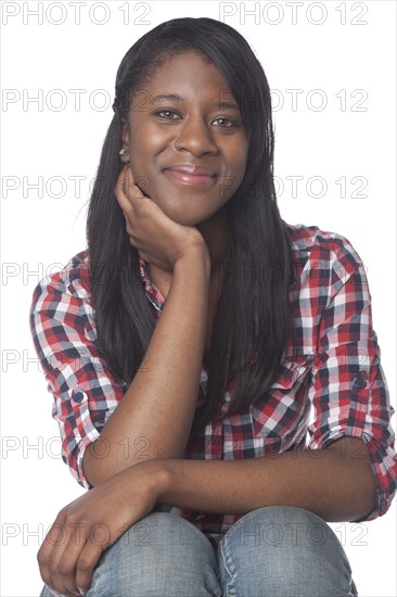 Mixed race woman with hand on chin