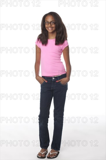 Smiling mixed race girl with hands in pockets