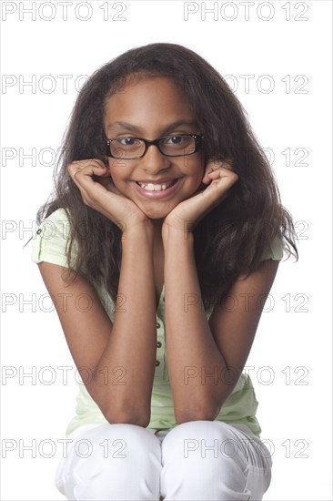 Smiling mixed race girl with head in hands