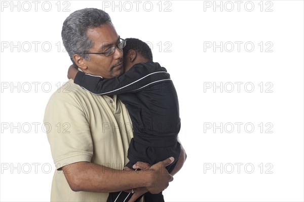 Hispanic father comforting son