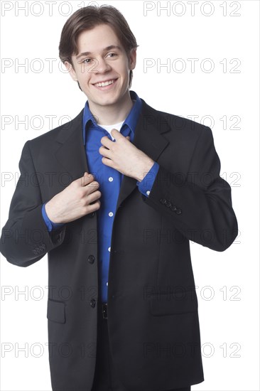 Caucasian businessman adjusting collar