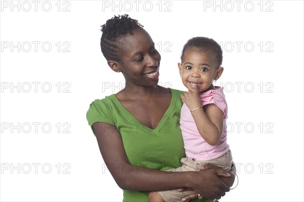 Black girl being carried by mother