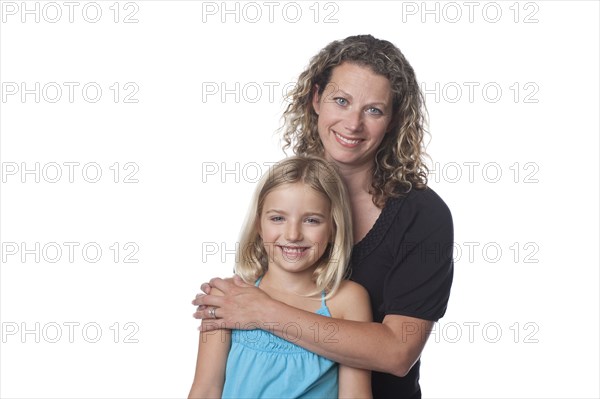 Caucasian mother hugging daughter