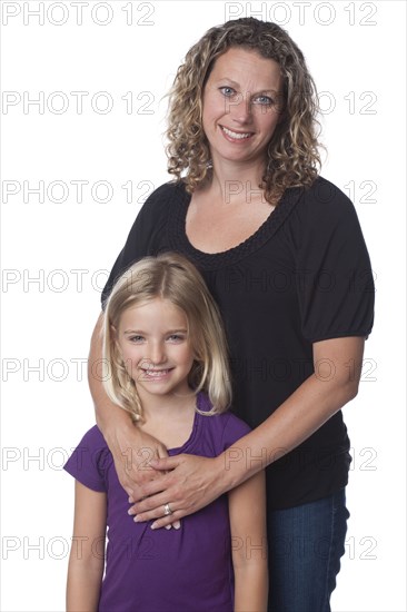 Caucasian mother hugging daughter