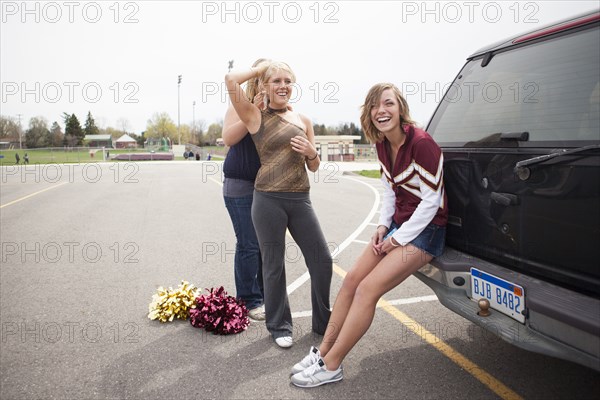 Caucasian cheerleaders talking in parking lot