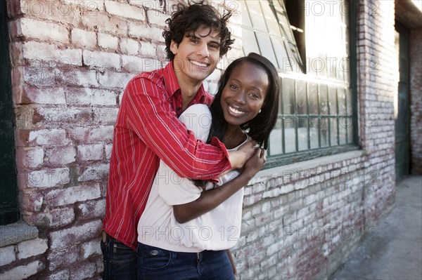 Couple hugging in urban area