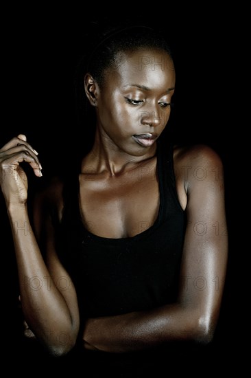 Serious African American woman looking down