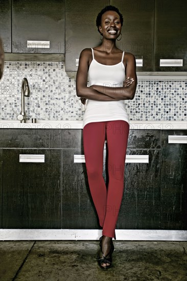 Black woman smiling in kitchen