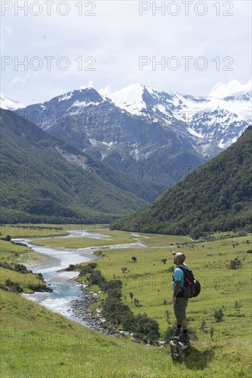 Chinese man standing near mountain river