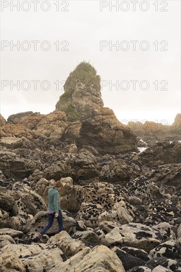 Caucasian woman walking on rocks