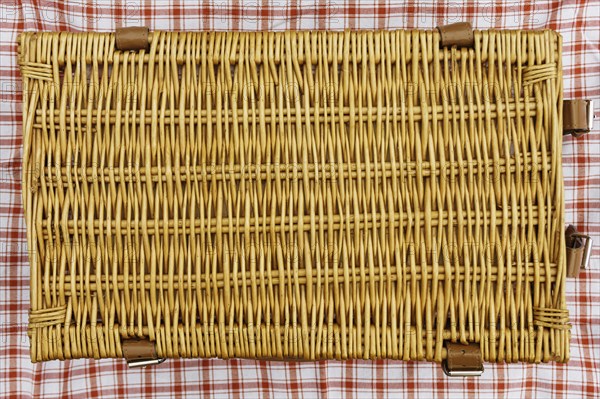 Overhead view of closed wicker picnic basket