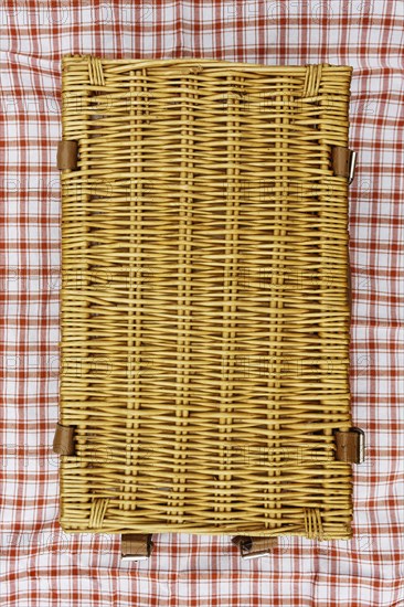 Overhead view of closed wicker picnic basket